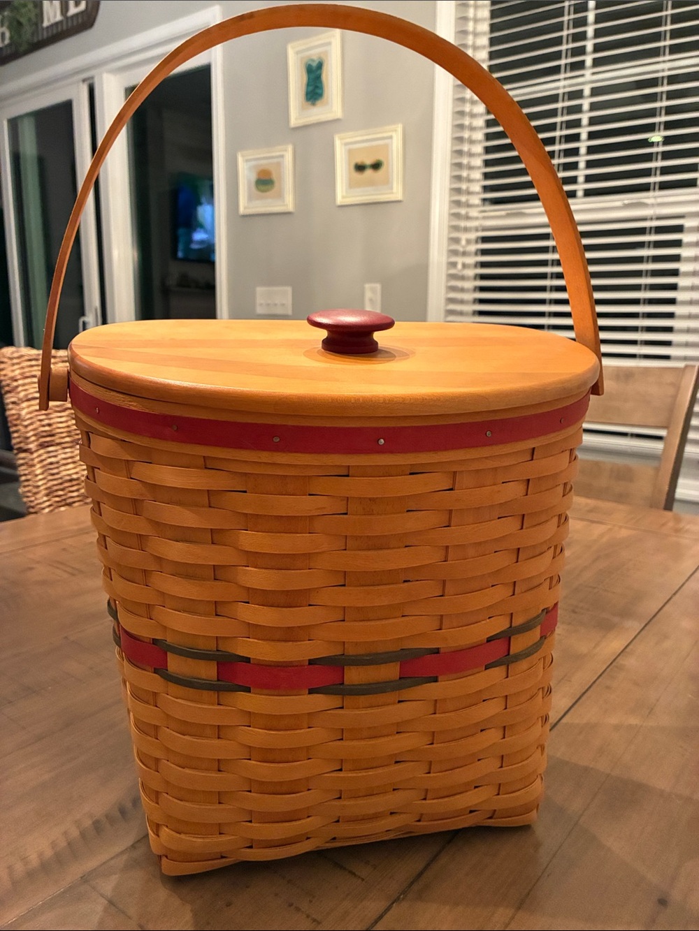 Longaberger Handwoven and signed 1998 Basket with Handle, lid and red trim.